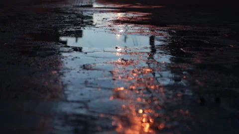 Low angle shot over cobblestone street with puddles Stock Footage 142872187