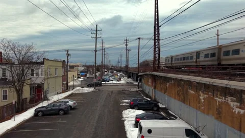 A low angle shot over a parking lot next to the Long Island Railroad on a Stock-Footage 332553297