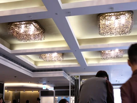 Low angle shot of people eating foods and worker serving food inside restaurant Stock Footage 83222220