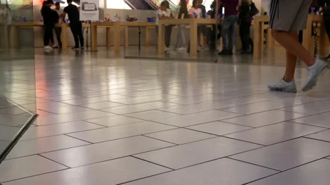Low angle shot of people playing new iphone inside the Apple store with 4k Stock Footage 116237696