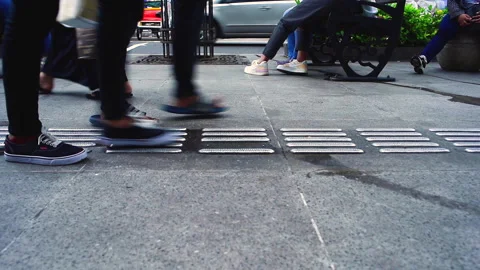 Low angle shot people walking passing on outdoor sidewalk floor Stock Footage 151163816