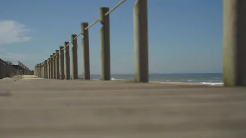 Low angle shot of pier on beach with clear blue sky, Portugal Stock-Footage 129065794