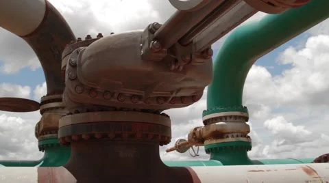 Low Angle Shot of pipes and valves at oil and gas well Stock Footage 45236820