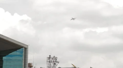 Low Angle Shot of a Plane flying over Davivienda Tower and Eldorado Avenue Stock Footage 42268500