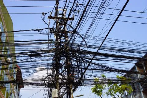 Low angle shot of a power pole with electricity cables Foto stock