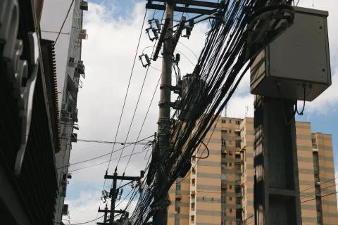 Low angle shot of a power pole with electricity cables Foto stock