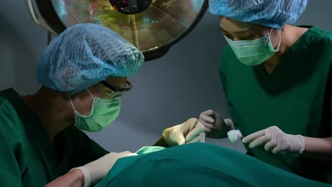 Low Angle Shot of Professional surgeons team performing surgery in operating  Stock Footage 171569900