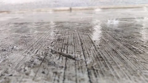 Low angle shot of rain falling on textured concrete surface Stock Footage 347954370