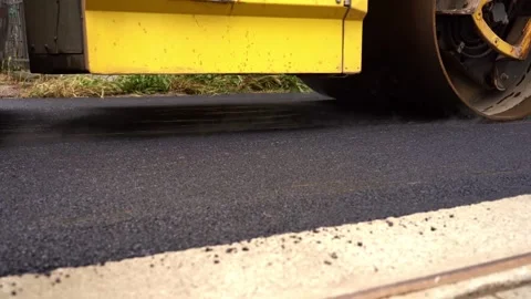Low Angle Shot of Road Roller Compacting Asphalt – 4K Stock Footage 311072895