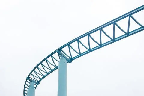 Low angle shot of roller coaster rails isolated on white sky background Stock Photos