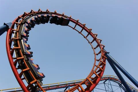 Low angle shot of a rollercoaster hump isolated on blue sky background Stock Photos