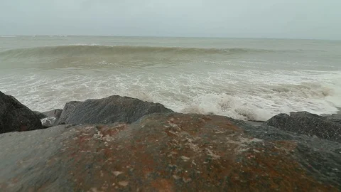 Low angle shot of rough sea waves near the shore. Stormy cloudy day on the be Stock Footage 91446154