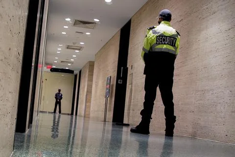 Low angle shot of security guards patrolling inside commercial building Stock Photos