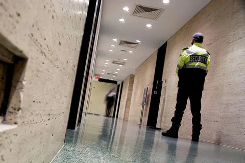 Low angle shot of security guards patrolling inside commercial building Stock Photos