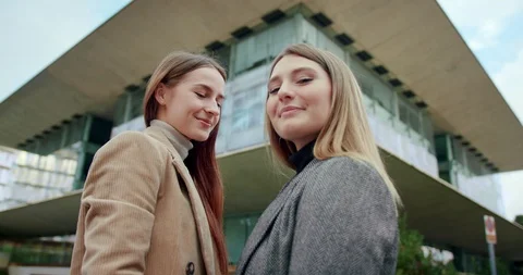 Low angle shot of self-confident pretty business females smiling looking to Stock Footage 120748175