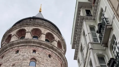 Low angle shot showcasing the Galata Tower and adjacent neoclassical Stock Footage 340155089