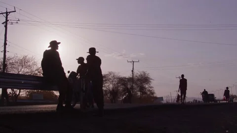 Low Angle shot - Silhoutte of people in the street of Turkana County Stock Footage 243685841