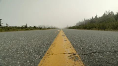 Low angle shot with slider of eerie road with fog in slow motion, 4k Stock Footage 112273986