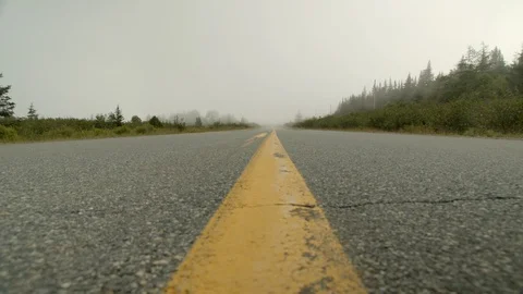 Low angle shot with slider of eerie road with fog in slow motion, 4k Stock Footage 112274001