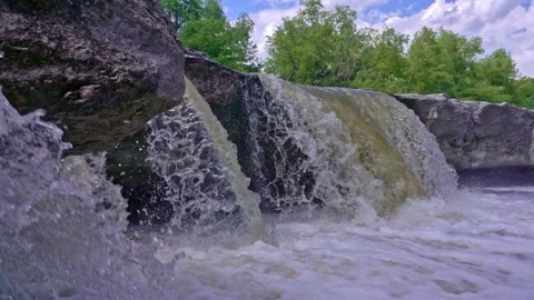 Low angle shot of small waterfall over rocky outcrop Video stock 142401261