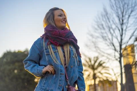 A low angle shot of a smiling attractive female in a park under the sunlight  Fotos Stock
