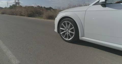 Low angle shot on sports car wheel driving at countryside asphalt road. Stock Footage 100031253