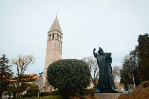 Low angle shot of a statue of Grgur Ninski near the church tower in Split, Croat Stock Photos