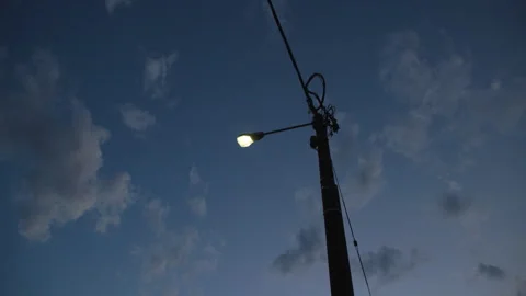 Low angle shot of a streetlight shining in the evening sky Stock Footage 242011732