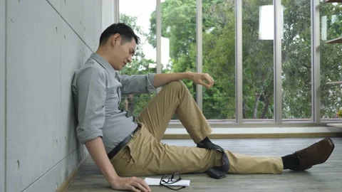 Low angle shot of stressed man sitting express negative emotions Stock Footage 148139786