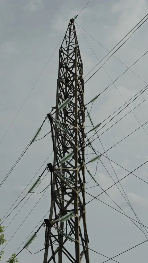 Low-angle shot of tall lattice electricity pylon Stock Footage 336004501