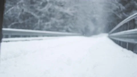 Low angle shot of three young ladies hiking together on a snowy day Vídeo Stock 83622048