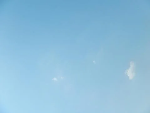 Low angle shot of tiny clouds in a blue sky for wallpapers Foto stock