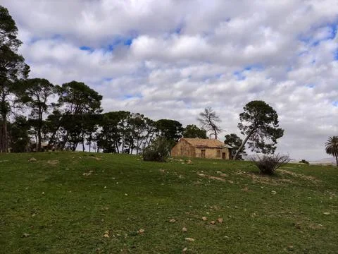 Low angle shot of a tiny house made of bricks in the field Stock Photos