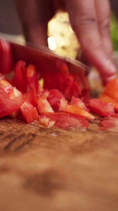 Low angle shot of tomato cuting with knife on a chopping board. Stock Footage 283363568