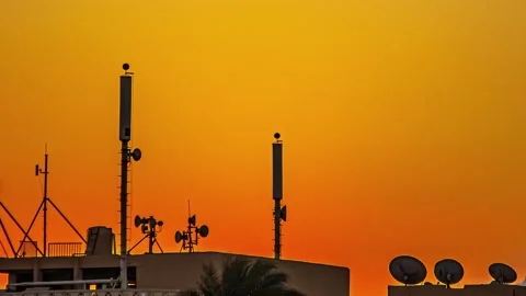 Low angle shot of tower antennas telecommunication cell phone over top of Stock Footage 237141362