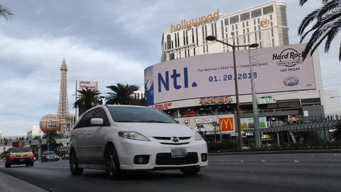 Low angle shot of traffic passing down the Las Vegas strip in the daytime Stock Footage 106622652