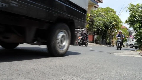 Low angle shot of traffic on a small town road, Bali Stock Footage 140309469