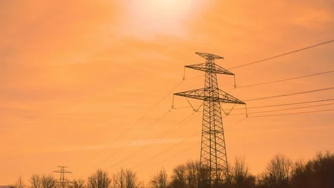 Low angle shot of a transmission tower under an orange sky Stock Footage 125531528
