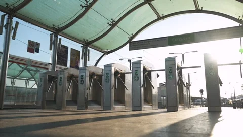 Low angle shot of turnstiles at sunset on the tram metro station with no people Stock Footage 251573473