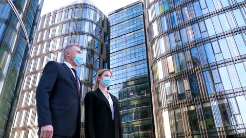 Low angle shot two businessmen in medical mask meet a businesswoman also wearing Stock Footage 134600593