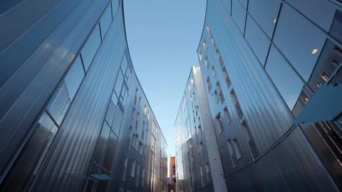 Low angle shot of two high-rise modern corporate buildings. POV shot walking Stock Footage 87844846