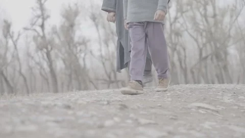 Low angle shot of two people walking in winter Stock-Footage 327595402