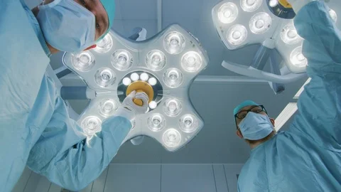 Low Angle Shot of Two Professional Surgeons Turning on Surgery Lights. Stock Footage 89657347