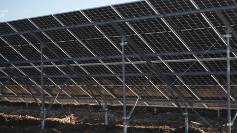 Low-Angle Shot Under Solar Panels Emphasizing Structural Design and Stock Footage 294528842