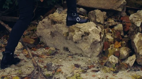 Low angle shot of unrecognizable person stepping on rocky mountain stones in Video stock 108730982