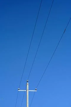 Low Angle Shot of Utility Pole with Power Lines Against Clear Blue Sky Stock Photos