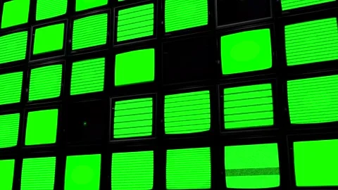 Low angle shot of a wall filled with TV monitor screens showing a flickering Stock Footage 267707351