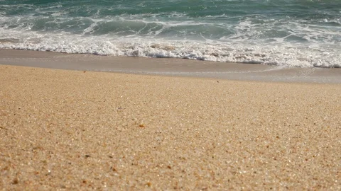 Low angle shot of waves breaking on sandy beach in summer Stock Footage 104422658