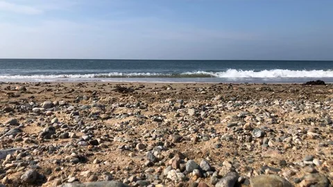 A low angle shot of waves breaking onto a beach Stock Footage 106002322