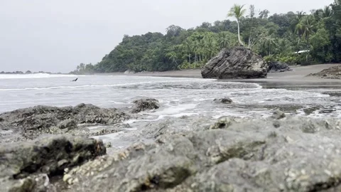 Low angle shot of waves sloshing on small rocks at remote Playa Terco Stock-Footage 272436697